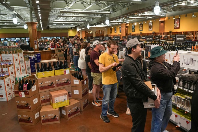 Fans wait in line to meet Guy Fieri at Twins Liquor at the Hancock Center on Thursday, March 28, 2024. Fieri came to Texas in support of his and Sammy Hagar’s Santo Spirits brand.